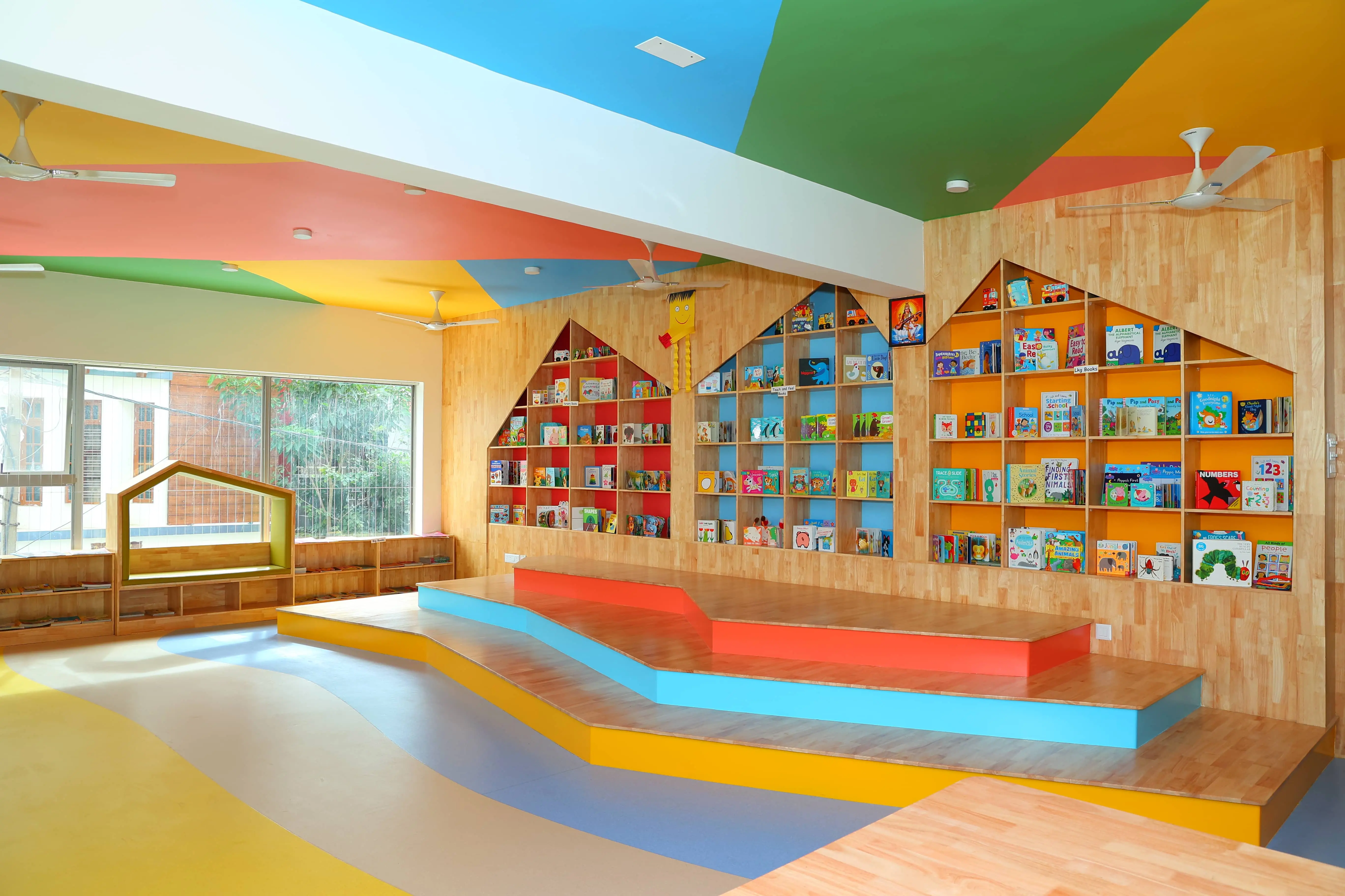 Our library boasts a cheerful, multi-colored ceiling and floor, creating an exciting and stimulating atmosphere that sparks creativity and joy